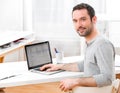 Young smiling man in front of a computer Royalty Free Stock Photo