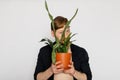 A young smiling man holds in his hands a small flower Royalty Free Stock Photo