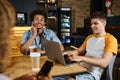 young smiling man networking on laptop