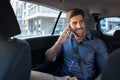 Young man talking over phone in taxi Royalty Free Stock Photo