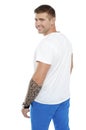 Young smiling man with tattoo on hand turning back Royalty Free Stock Photo