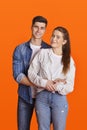 Young smiling man and woman in casual and denim hugging and looking at camera Royalty Free Stock Photo