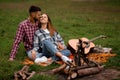 young smiling man and woman relaxing in the park. Love story. Royalty Free Stock Photo