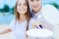 Young couple in love playing with matkot rackets