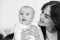 Young smiling mother looks at her child. Royalty Free Stock Photo