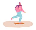 Young smiling muslim woman in hijab enjoying skateboarding outdoors