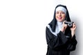 Young smiling nun with photo camera Royalty Free Stock Photo