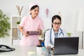 Young smiling nurse using clipboard writing note Royalty Free Stock Photo