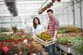 Young smiling people florists working in the garden Royalty Free Stock Photo