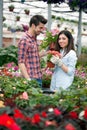 Young smiling people florists working in the garden Royalty Free Stock Photo