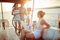 Young people sailing on boat together and enjoy at sunset on vacation