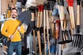 Man choosing new shovel in garden equipment shop Royalty Free Stock Photo