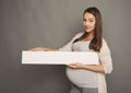 Young pregnant woman with blank white paper Royalty Free Stock Photo