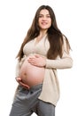 Young smiling pregnant woman grabbing her tummy