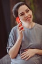 Young smiling pregnant woman touching belly talking on mobile phone with friend while spending time at home Royalty Free Stock Photo