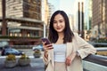 Young Asian business woman professional standing in city holding phone. Royalty Free Stock Photo