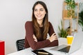 Young smiling pretty business woman sitting at table at home office with laptop Royalty Free Stock Photo