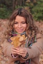 Young, smiling and pretty woman in the autumn park Royalty Free Stock Photo