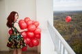 Young smiling red-haired woman holds in hand bunch