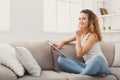 Young redhead girl with digital tablet at home Royalty Free Stock Photo