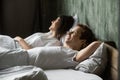 Young smiling satisfied couple in love lying in bed Royalty Free Stock Photo