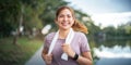 Young smiling sporty woman running in park in the morning. Fitness girl jogging in park Royalty Free Stock Photo