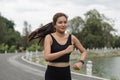 Young smiling sporty woman running in park in the morning. Fitness girl jogging in park Royalty Free Stock Photo