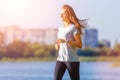 Young smiling woman running in park in the morning Royalty Free Stock Photo