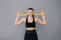 Young smiling strong athletic fitness trainer, a female instructor in a black tracksuit is spending time in the home gym with a fi Royalty Free Stock Photo