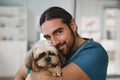 Young smiling vet clinician holding cute fluffy yorkshire terrier