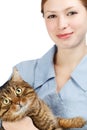 Young smiling veterinarian woman and adult big-eyed tabby cat