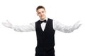 Young smiling waiter opens his arms in welcome Royalty Free Stock Photo