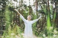 Young smiling woman with beads practice yoga outdoors in the forest. Physical and mental health Royalty Free Stock Photo