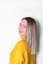 Young smiling woman with blond straight hair is posing half-turned Royalty Free Stock Photo