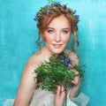 Young smiling tender woman with blue flowers on light blue background. Spring beauty portrait Royalty Free Stock Photo