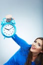 Young smiling woman in blue hold watch. Beautiful smiling girl Royalty Free Stock Photo