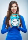 Young smiling woman in blue hold watch. Beautiful smiling girl Royalty Free Stock Photo