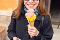 Young Smiling Woman in a Coat Holds Ice Cream Royalty Free Stock Photo