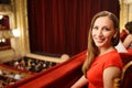 Young smiling woman in dress sitting in theatre Royalty Free Stock Photo