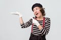 Young smiling woman dressed like mime showing open hand palm with copy space Royalty Free Stock Photo