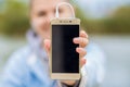 Young smiling woman in excellent spirits with a phone and listens to music Royalty Free Stock Photo