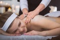 Young smiling woman getting firming sugar scrub therapy on her b Royalty Free Stock Photo