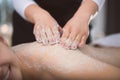 Young smiling woman getting firming sugar scrub therapy on her b Royalty Free Stock Photo