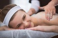 Young smiling woman getting firming sugar scrub therapy on her b Royalty Free Stock Photo