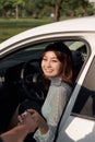 Young smiling woman getting keys of a new car. Concept for car rental Royalty Free Stock Photo