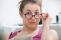 Young and smiling woman with glasses, reading newspaper Royalty Free Stock Photo