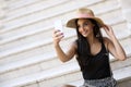 Young smiling woman in hat making selfie with smartpho Royalty Free Stock Photo