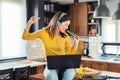 Young smiling woman with headphones working from home, taking break listening music and singing Royalty Free Stock Photo