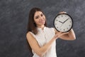 Young smiling woman holding clocks Royalty Free Stock Photo