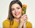 Young smiling woman holding glass with carrot. Royalty Free Stock Photo